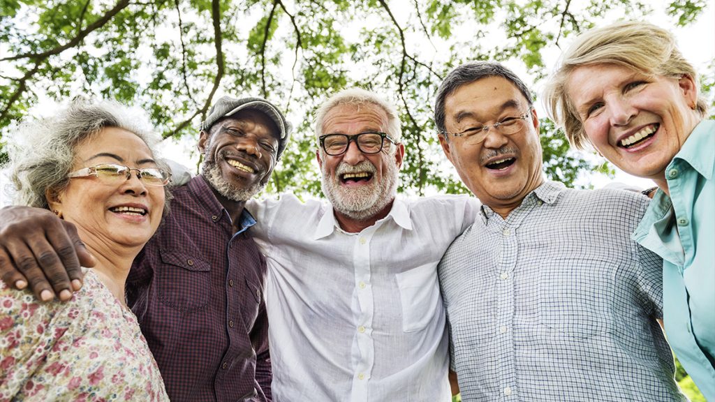 A group of older people smiling at the camera.